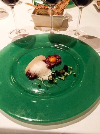 Venison tartar with quail's egg marinated in soy sauce and horseradish foam