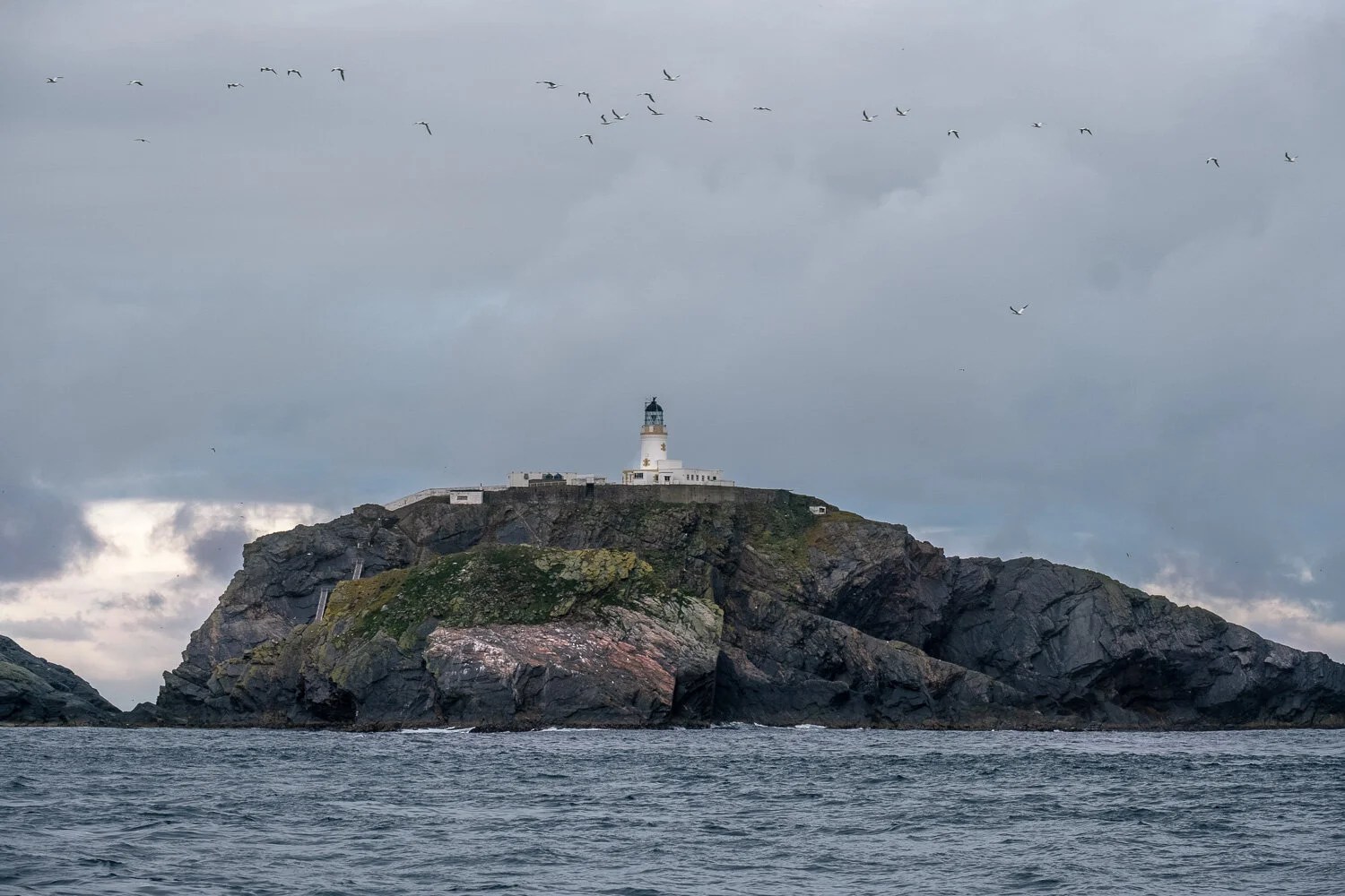  Northernmost point in the UK. If you look closely to the left of the lighthouse you can see two ladders on the side of the island. Climbing these plus the lower one you cant see is the only way to get to the lighthouse from a boat for people and supplies. 