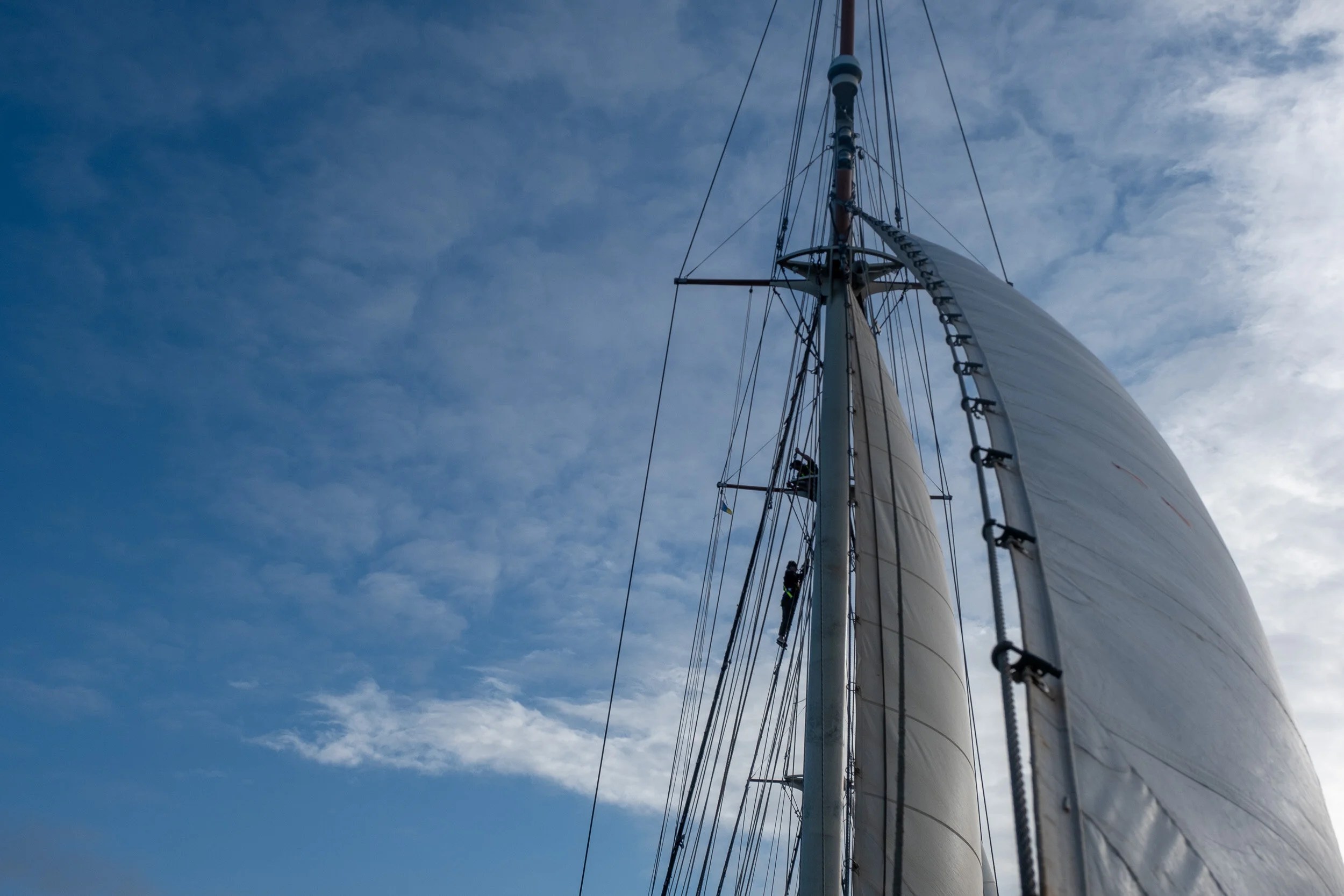 From the bowsprit looking back to the inner jib and watching someone climbing the mast
