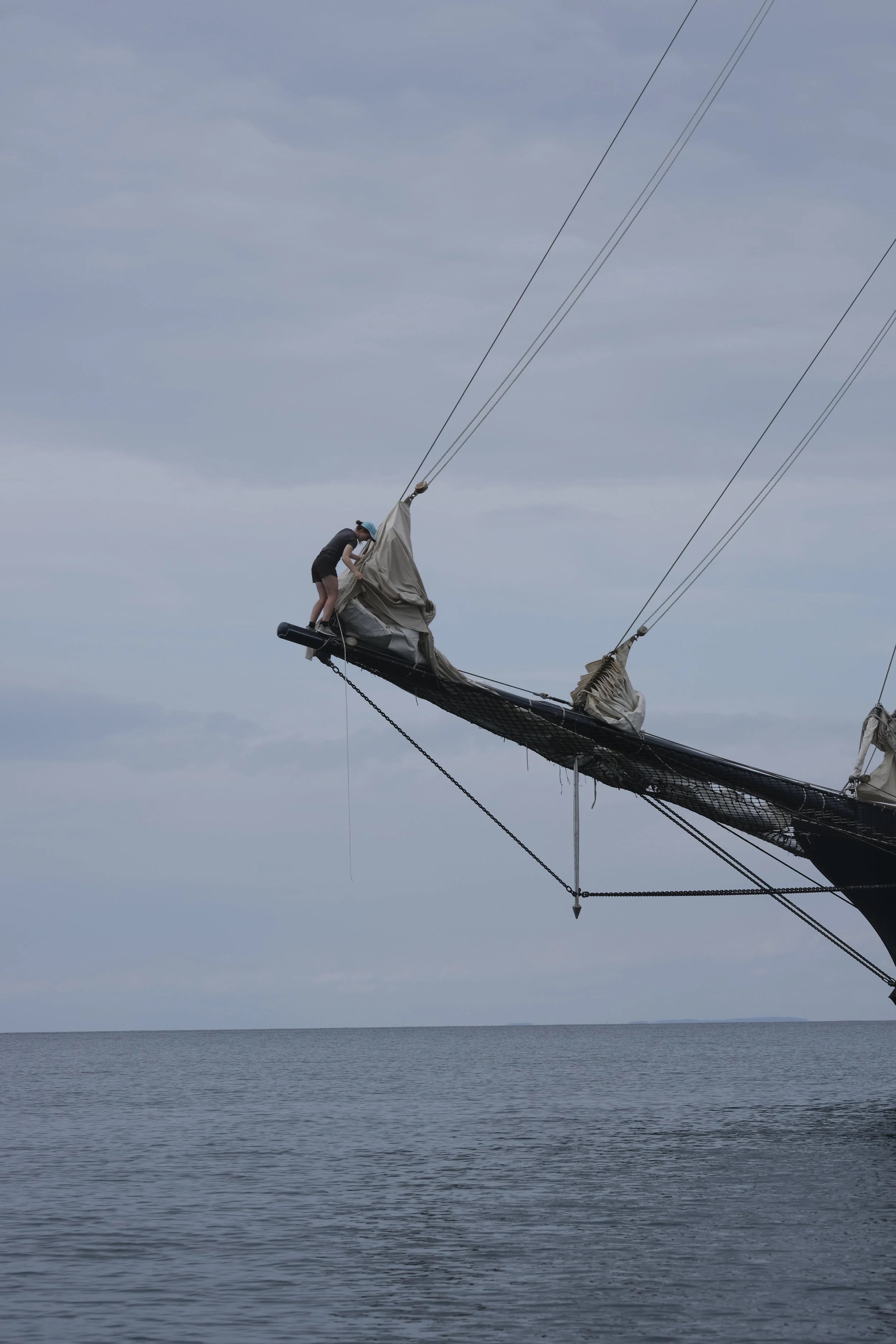  Alice, our figurehead, putting sail covers on the outer jib 