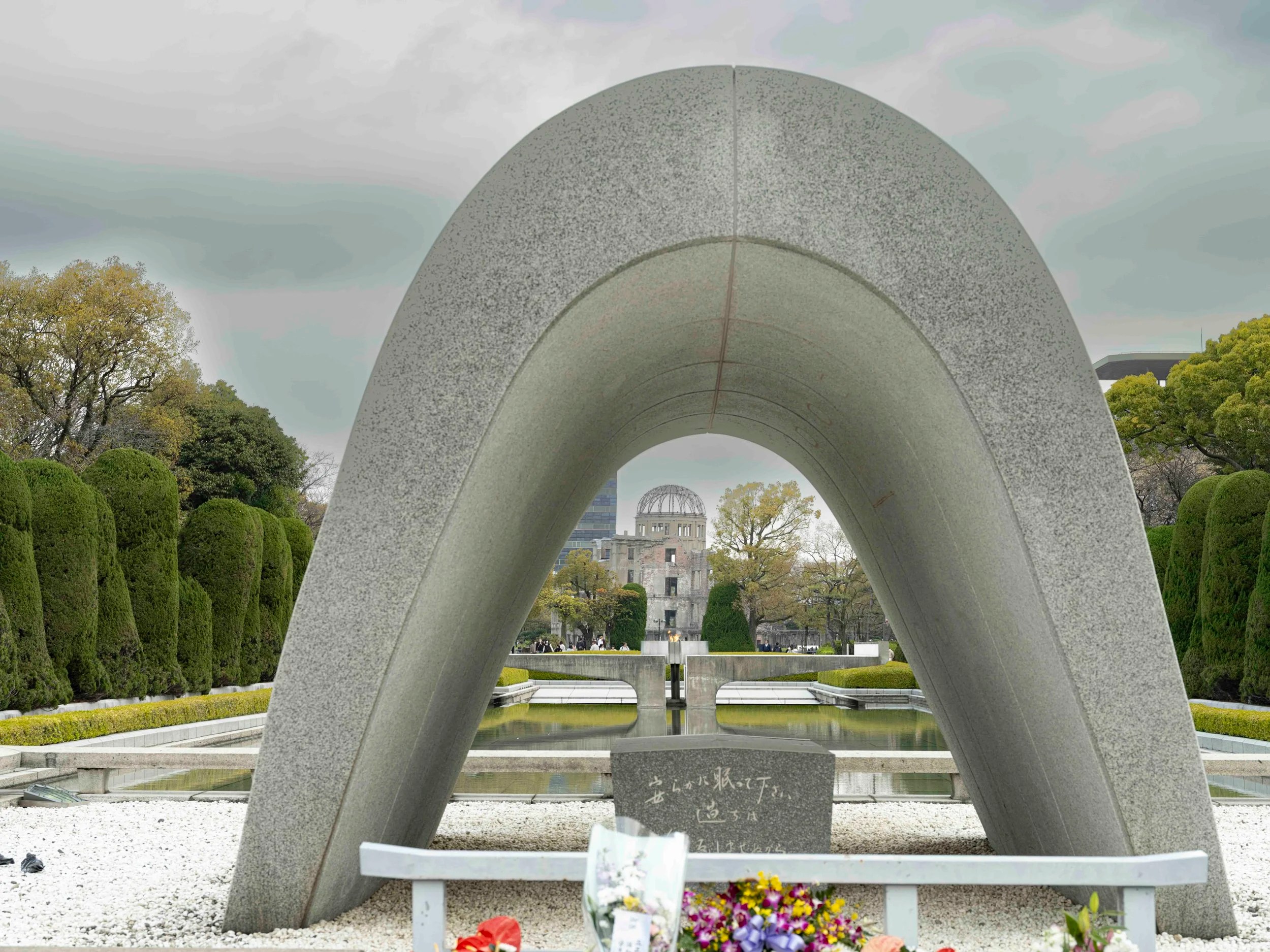  Memorial arch to the Hiroshima dead looking through the arch to the eternal flame and on to the only remaining building from the blast. 